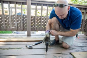 Deck Repair by Salem worker with power tool