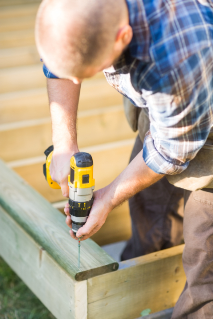 Salem Deck Contractor screwing in wooden deck